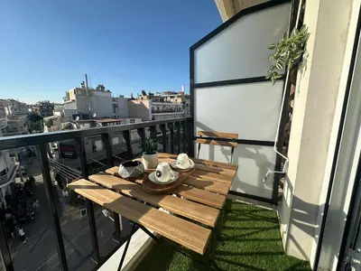 a wooden table on a balcony with a view at Glyfada center seaview B in Athens