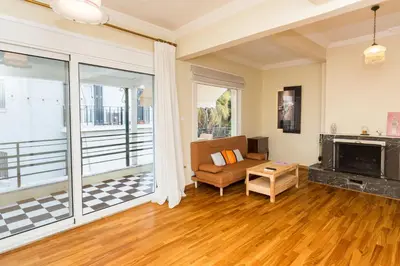 a living room with a couch and a fireplace at Acropolis Aura Vintage Stays in Athens in Athens