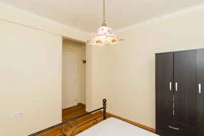 a bedroom with a bed and a chandelier at Acropolis Aura Vintage Stays in Athens in Athens