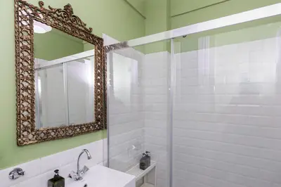 a bathroom with a mirror and a sink at Acropolis Aura Vintage Stays in Athens in Athens