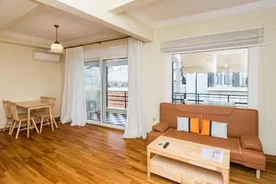 a living room with a couch and a table at Acropolis Aura Vintage Stays in Athens in Athens