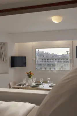 a dining room with a table and a window at Central Athenian penthouse Acropolis in Athens