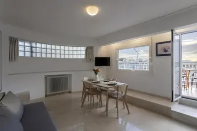 a living room with a table and chairs and a couch at Central Athenian penthouse Acropolis in Athens