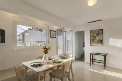 a white dining room with a table and chairs at Central Athenian penthouse Acropolis in Athens