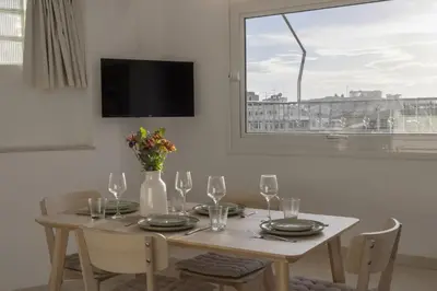 a dining room table with wine glasses and a window at Central Athenian penthouse Acropolis in Athens