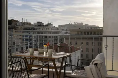 a table on a balcony with a view of a city at Central Athenian penthouse Acropolis in Athens