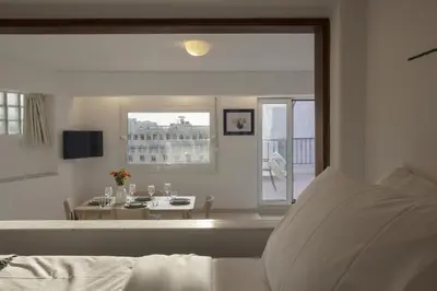 a white living room with a table and a window at Central Athenian penthouse Acropolis in Athens