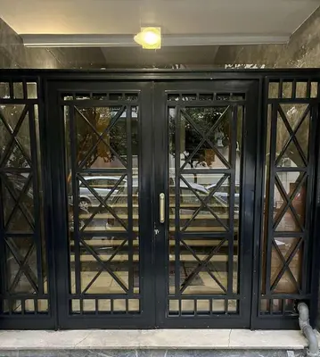 a black door with glass panels on a building at Athens TAN Luxury Apartment In City Center 78m2 in Athens