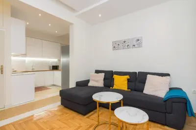 a living room with a couch and two tables at Athens TAN Luxury Apartment In City Center 78m2 in Athens