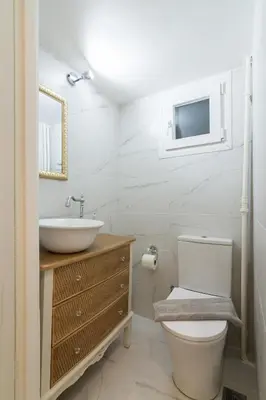 a bathroom with a toilet and a sink and a mirror at Athens TAN Luxury Apartment In City Center 78m2 in Athens