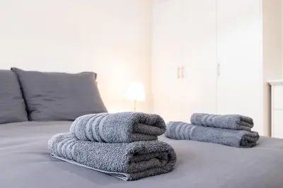 a pile of towels sitting on top of a bed at Athens TAN Luxury Apartment In City Center 78m2 in Athens
