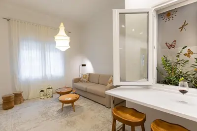 a living room with a couch and a table at Votsala Deluxe & Modern Apartments in Piraeus in Piraeus