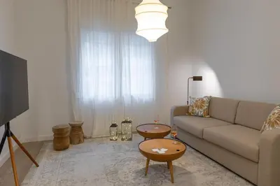a living room with a couch and a table at Votsala Deluxe & Modern Apartments in Piraeus in Piraeus