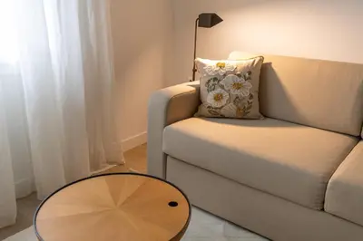 a living room with a couch and a table at Votsala Deluxe & Modern Apartments in Piraeus in Piraeus