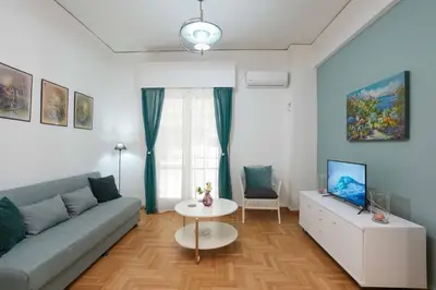 a living room with a couch and a table at Peppy's house in Athens