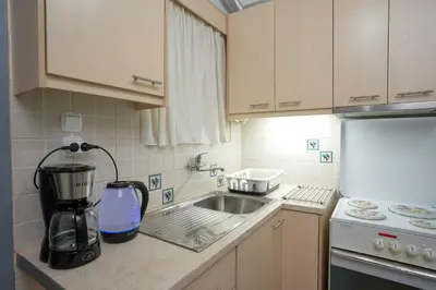 a kitchen with a sink and a mixer on a counter at Peppy's house in Athens