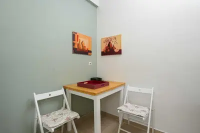 a small table with two chairs and a red box on it at Peppy's house in Athens