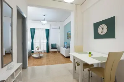 a living room with a white table and chairs at Peppy's house in Athens