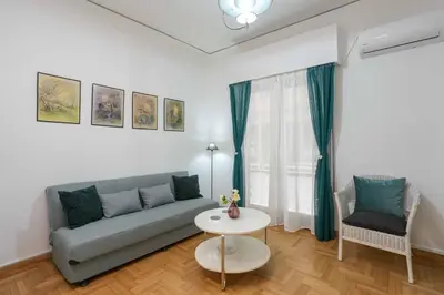 a living room with a couch and a table at Peppy's house in Athens