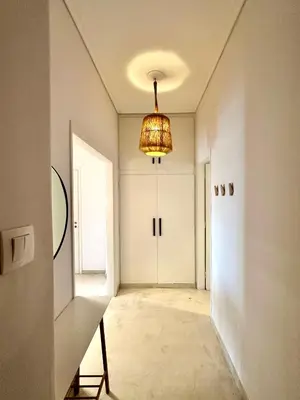 an empty hallway with a chandelier and a door at Modern 2BD with City View Near Acropolis in Athens