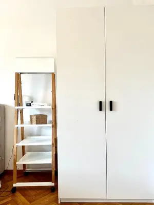 a closet with white doors and a shelf at Modern 2BD with City View Near Acropolis in Athens