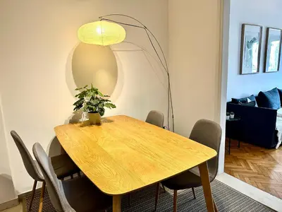 a dining room table with a potted plant on it at Modern 2BD with City View Near Acropolis in Athens
