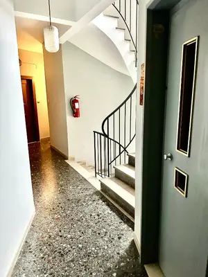 a hallway with stairs and a fire hydrant on the wall at Modern 2BD with City View Near Acropolis in Athens