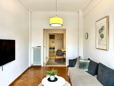 a living room with a couch and a table at Modern 2BD with City View Near Acropolis in Athens