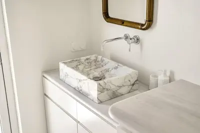 a bathroom with a marble sink on a counter at Designer comfy penthouse, Pagrati-