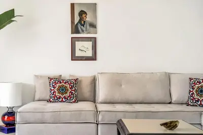 a living room with a couch and a picture on the wall at Designer comfy penthouse, Pagrati-
