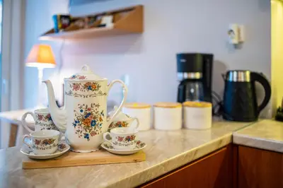 a counter with two cups and a tea pot on it at Suite home in Athens