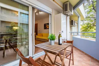 a table with a bottle of wine on a balcony at Suite home in Athens