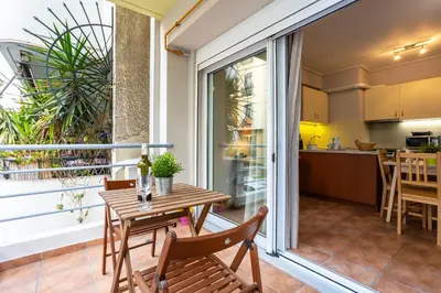 a balcony with a table and chairs and a kitchen at Suite home in Athens