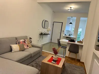 a living room with a couch and a table at Primavera 2 bedrooms apartment in Athens