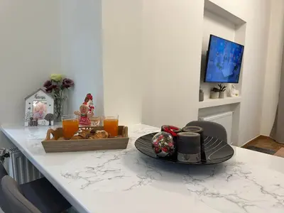 a kitchen counter with a table with a plate of food at Primavera 2 bedrooms apartment in Athens