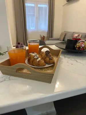 a tray of pastries and orange juice on a table at Primavera 2 bedrooms apartment in Athens