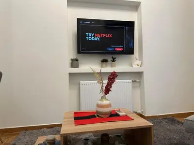 a living room with a tv and a vase on a table at Primavera 2 bedrooms apartment in Athens