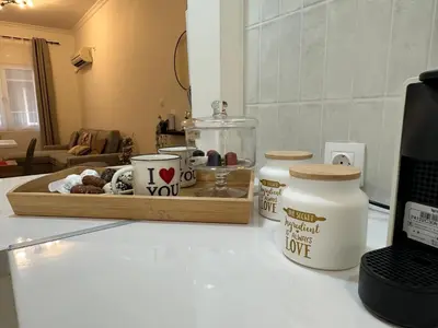 a kitchen counter with a counter top with a table with a counter top at Primavera 2 bedrooms apartment in Athens