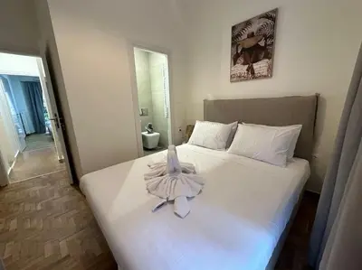 a bedroom with a bed with a robe on it at Primavera 2 bedrooms apartment in Athens