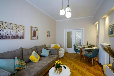 a living room with a couch and a table at central elegant apartment in koukaki,near acropoli in Athens