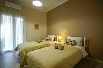 a bedroom with two beds with stuffed animals on them at central elegant apartment in koukaki,near acropoli in Athens