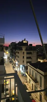 a view of a city at night from a balcony at central elegant apartment in koukaki,near acropoli in Athens