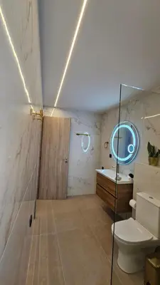 a bathroom with a toilet and a sink and a mirror at Mark1 by Apollo in Markopoulo
