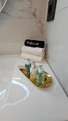 a bathroom with a tray with two candles and towels at Mark1 by Apollo in Markopoulo