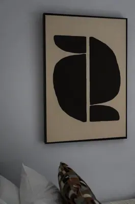 a picture hanging on a wall with a couch at Piraeus Gem - Netflix, Nespresso and Style in Piraeus