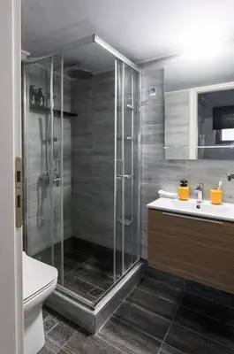 a bathroom with a shower and a toilet and a sink at Piraeus Gem - Netflix, Nespresso and Style in Piraeus