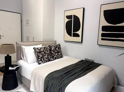 a bedroom with a bed with black and white at Piraeus Gem - Netflix, Nespresso and Style in Piraeus