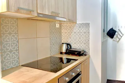 a kitchen with a coffee pot on a counter at A Very Friendly and Central Home in Athens