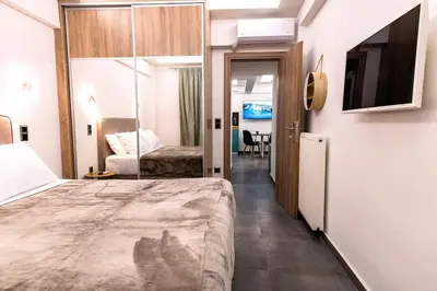 a hotel room with a bed and a television at Fix Central Athens Nomads in Athens