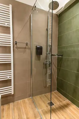 a shower with a glass door in a bathroom at Fix Central Athens Nomads in Athens